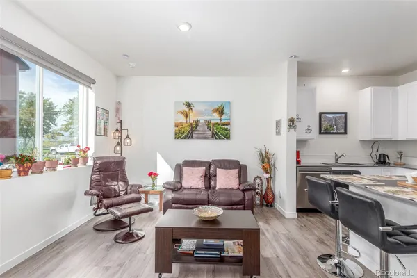 a living room with furniture fireplace and window