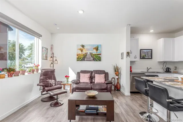 a living room with furniture fireplace and window