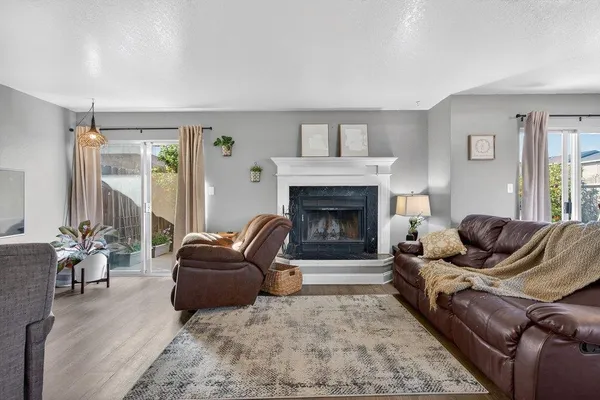 a living room with furniture and a fireplace