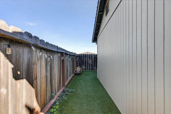 a view of a backyard with wooden fence and a stairs