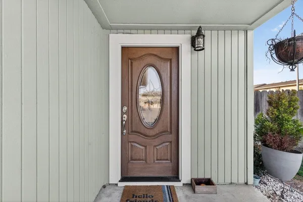 a view of a hallway with wooden floor and closet