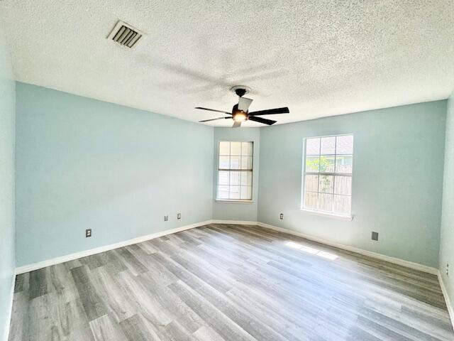 129 Wright Circle Niceville, FL 32578 - Photo 14 of 17 a view of empty room with wooden floor and fan