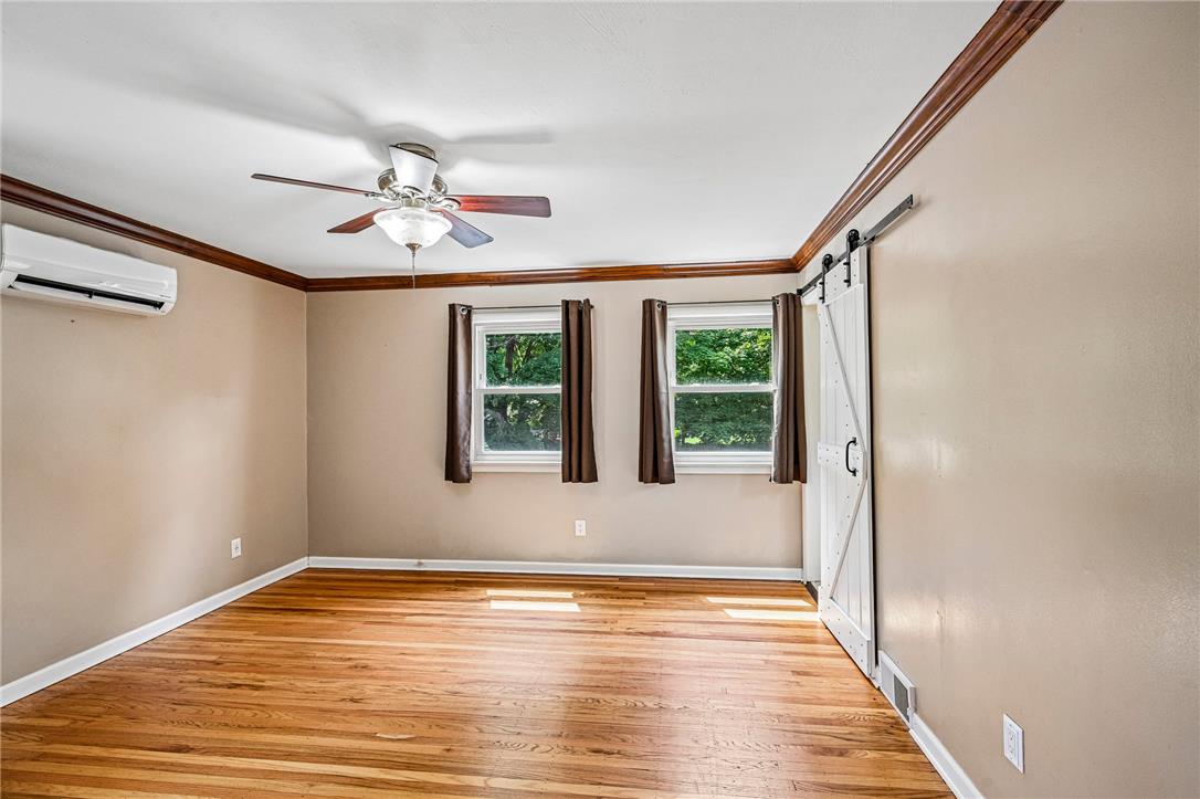 2428 Nottingham Road Bethlehem, PA 18017 - Photo 26 of 48 Primary BR - A restful bedroom offers hardwood flooring and ample natural light with a barn slider leading to ensuite