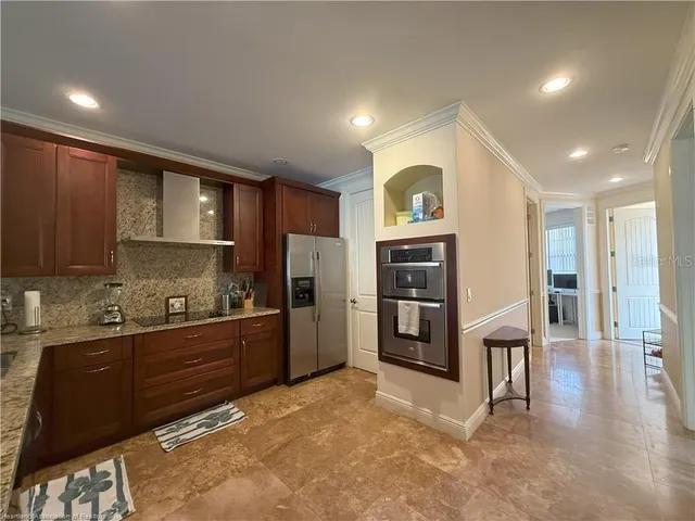a kitchen with stainless steel appliances a refrigerator and a stove top oven