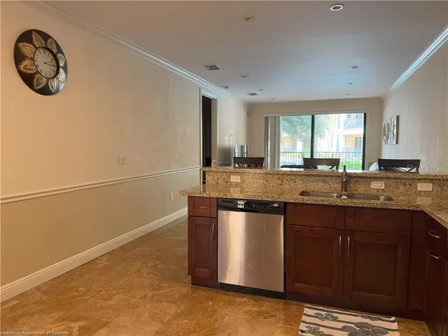 a view of living room with granite countertop furniture a rug a flat screen tv and a window