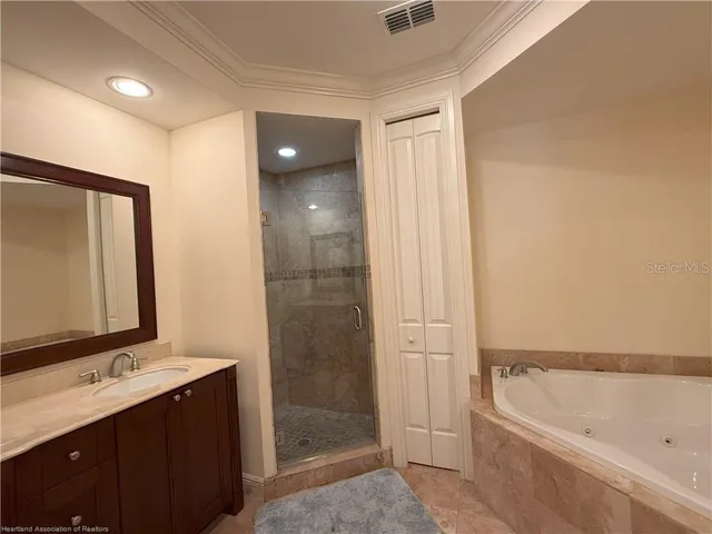 a bathroom with a tub sink and mirror