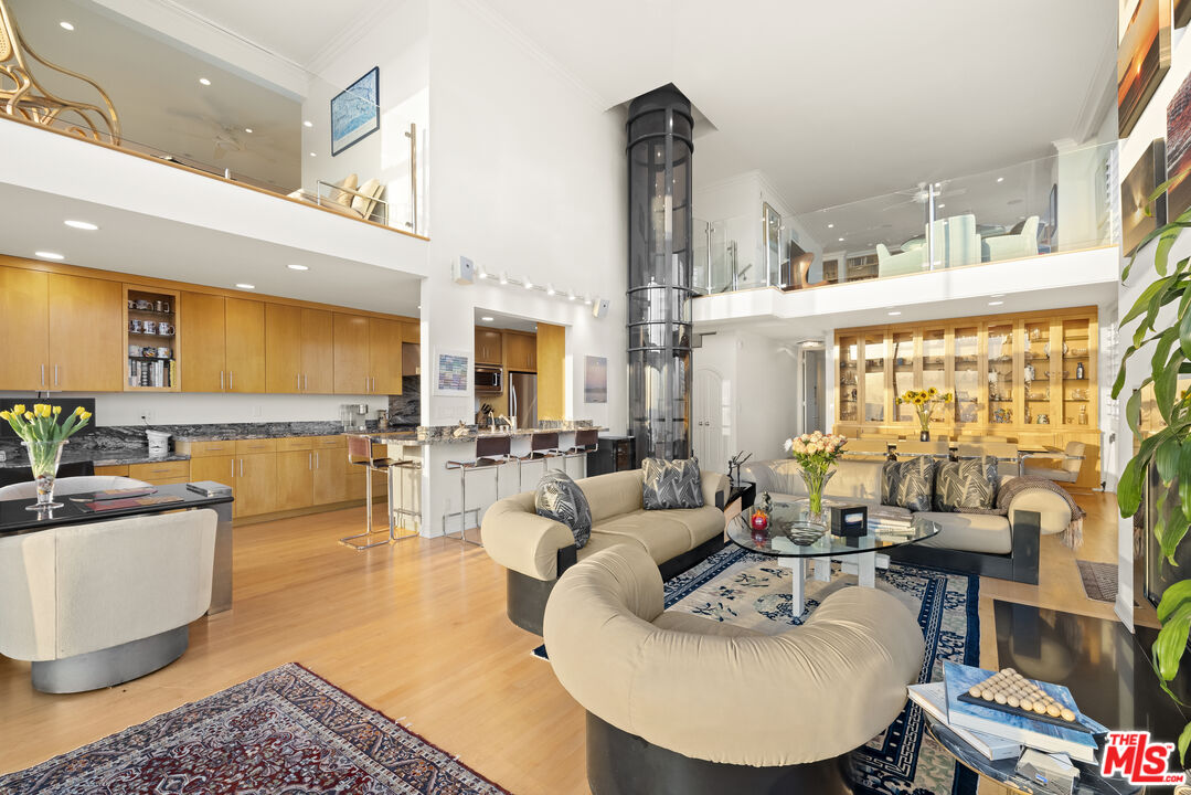 1 Northstar Street, Unit PH1 Marina del Rey, CA 90292 - Photo 4 of 18 a living room with furniture a large window and a table