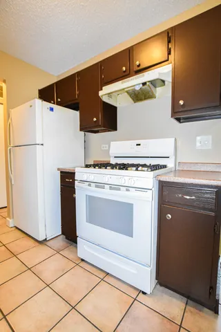 a kitchen with a stove and a refrigerator