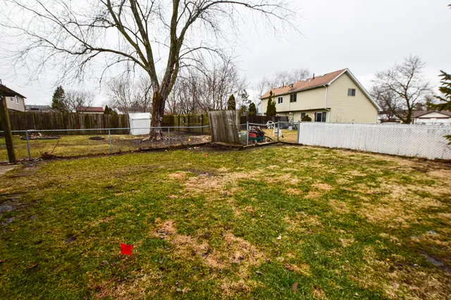 a view of a white house with a yard and snow