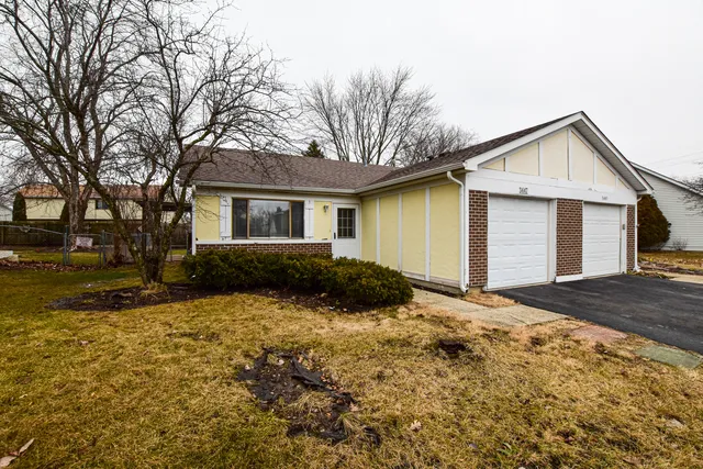 a view of a house with a yard covered in snow