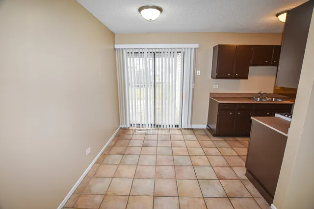a view of a kitchen with a sink and a stove top oven