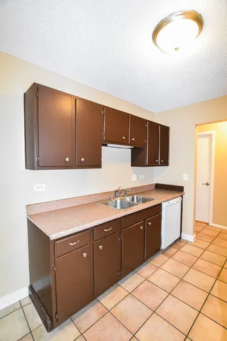 a kitchen with stainless steel appliances granite countertop a sink and cabinets