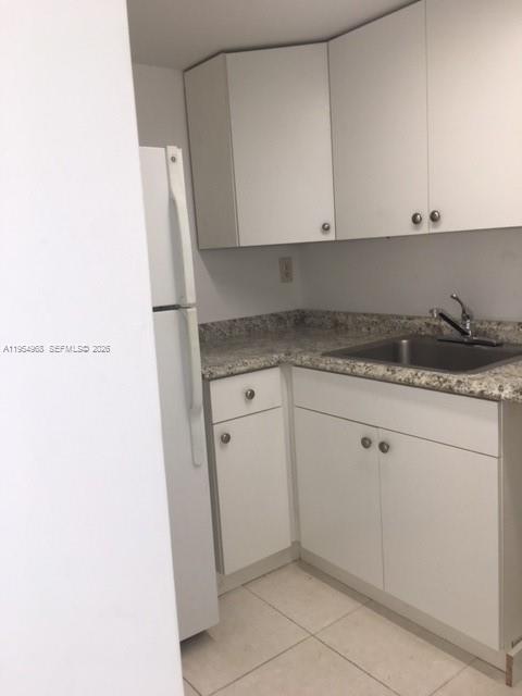 4801 Northwest 7th, Unit 40216 Miami, FL 33126 - Photo 6 of 14 a kitchen with a sink and cabinets