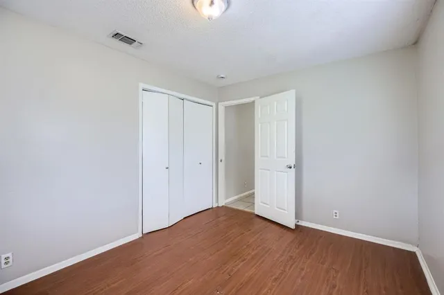 a view of an empty room and wooden floor