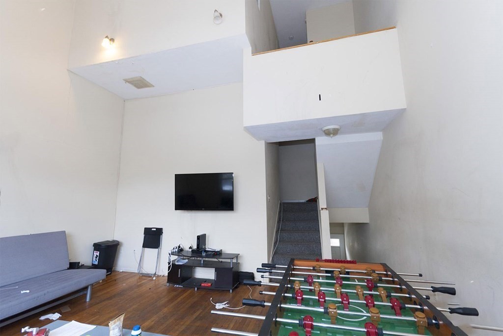 a bedroom with furniture and a flat screen tv