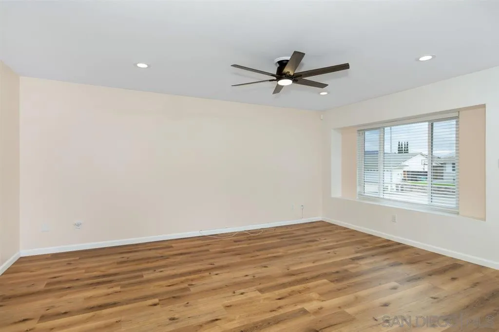 10116 Pinewood View Santee, CA 92071 - Photo 5 of 24 a view of empty room with wooden floor and fan