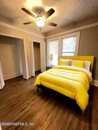 a bedroom with a bed and wooden floor