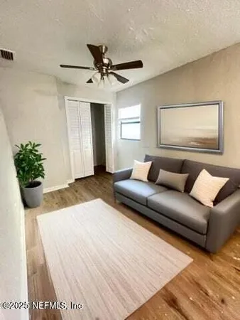 a living room with a couch and a potted plant