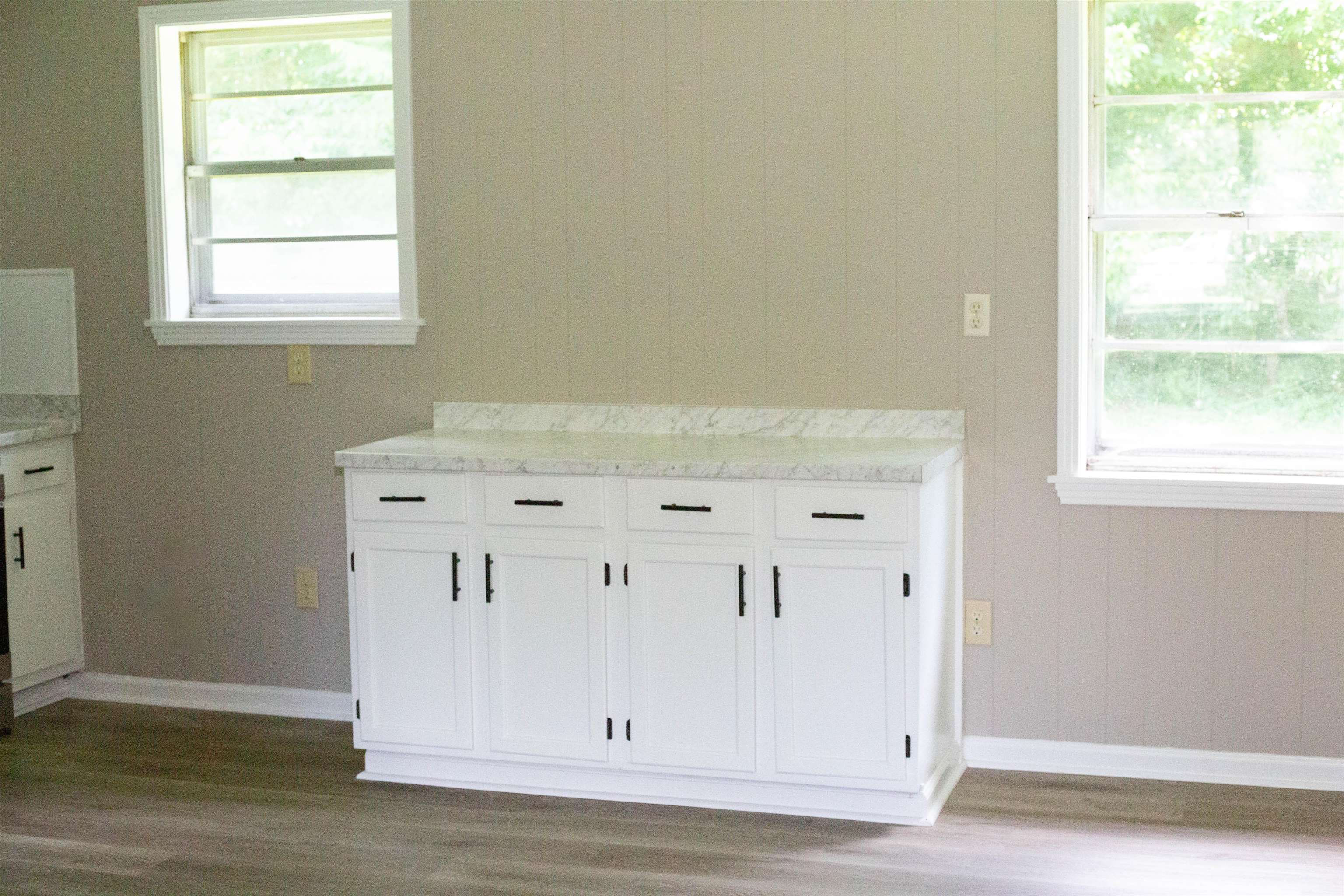 583 Armstrong Road Drummonds, TN 38023 - Photo 6 of 14 White cabinetry featuring black hardware and a light-toned countertop