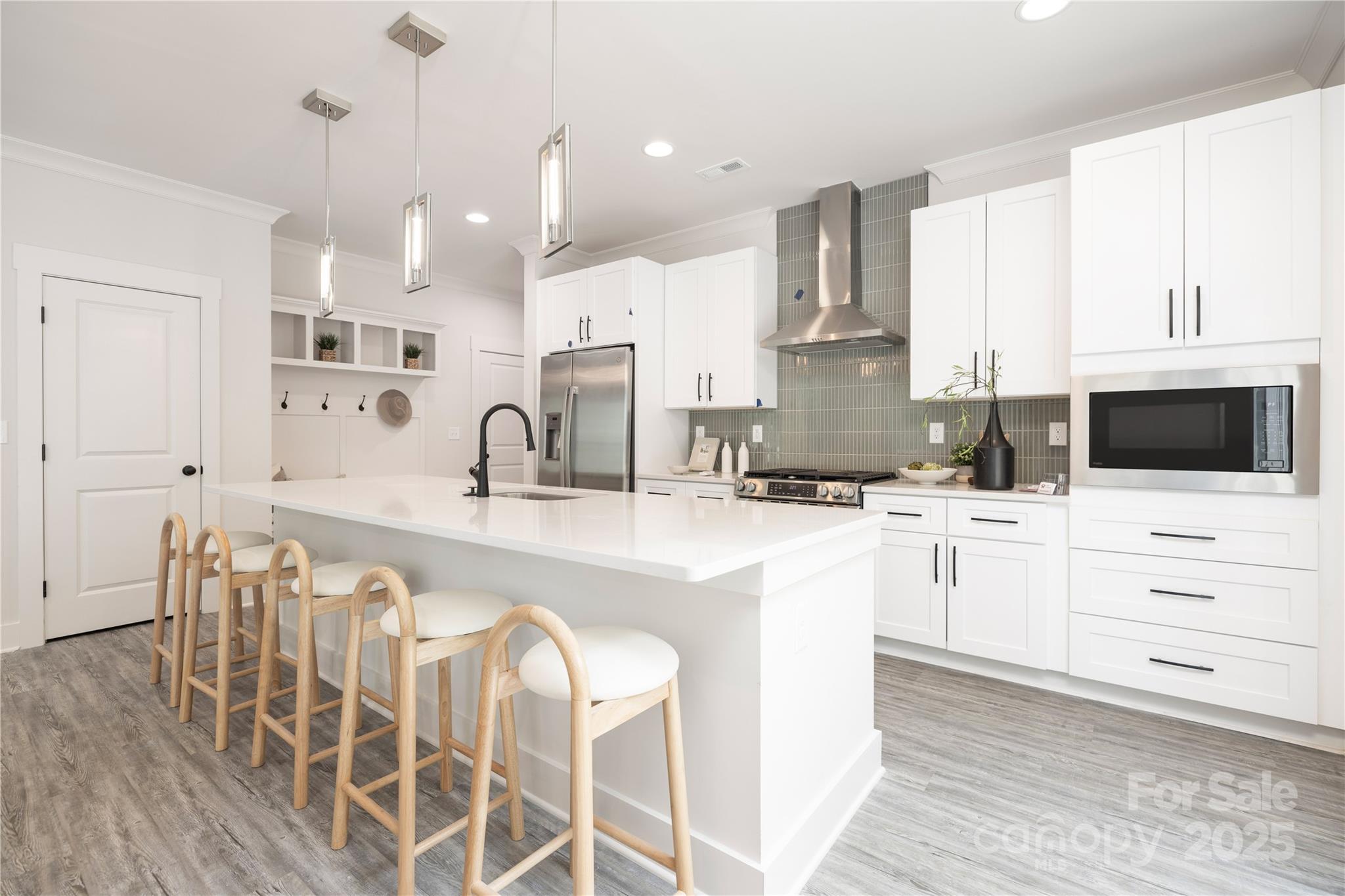 8937 Penstemons Drive Charlotte, NC 28215 - Photo 11 of 31 a kitchen with stainless steel appliances kitchen island granite countertop a sink and cabinets