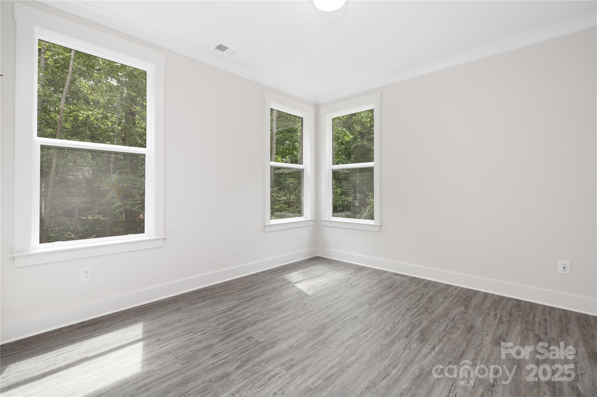 8937 Penstemons Drive Charlotte, NC 28215 - Photo 12 of 31 an empty room with wooden floor and windows