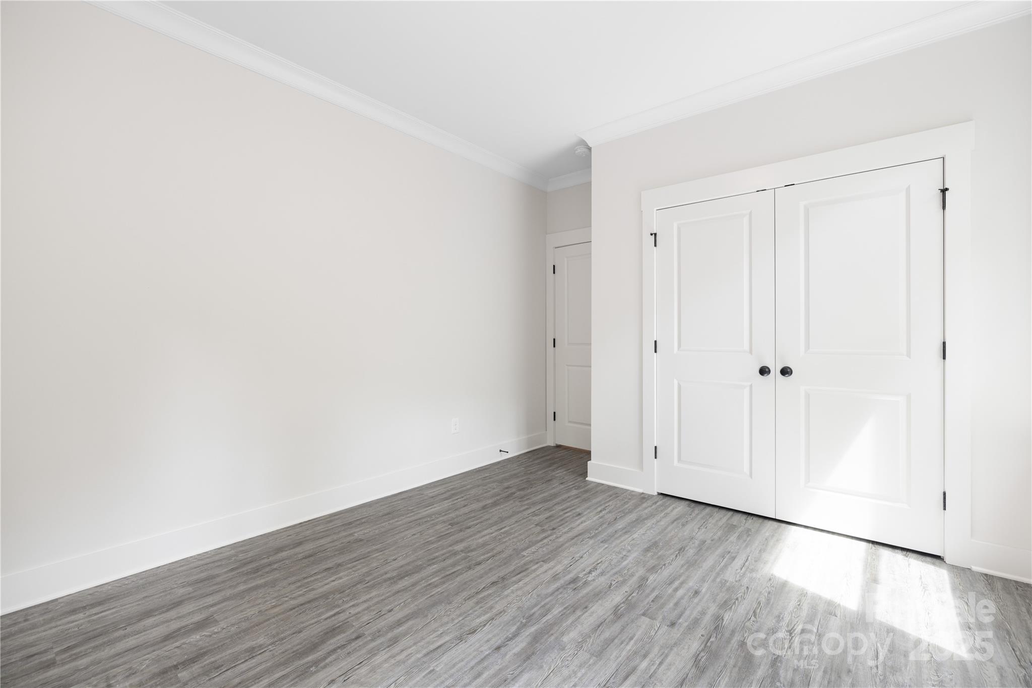 8937 Penstemons Drive Charlotte, NC 28215 - Photo 13 of 31 a view of an empty room with wooden floor