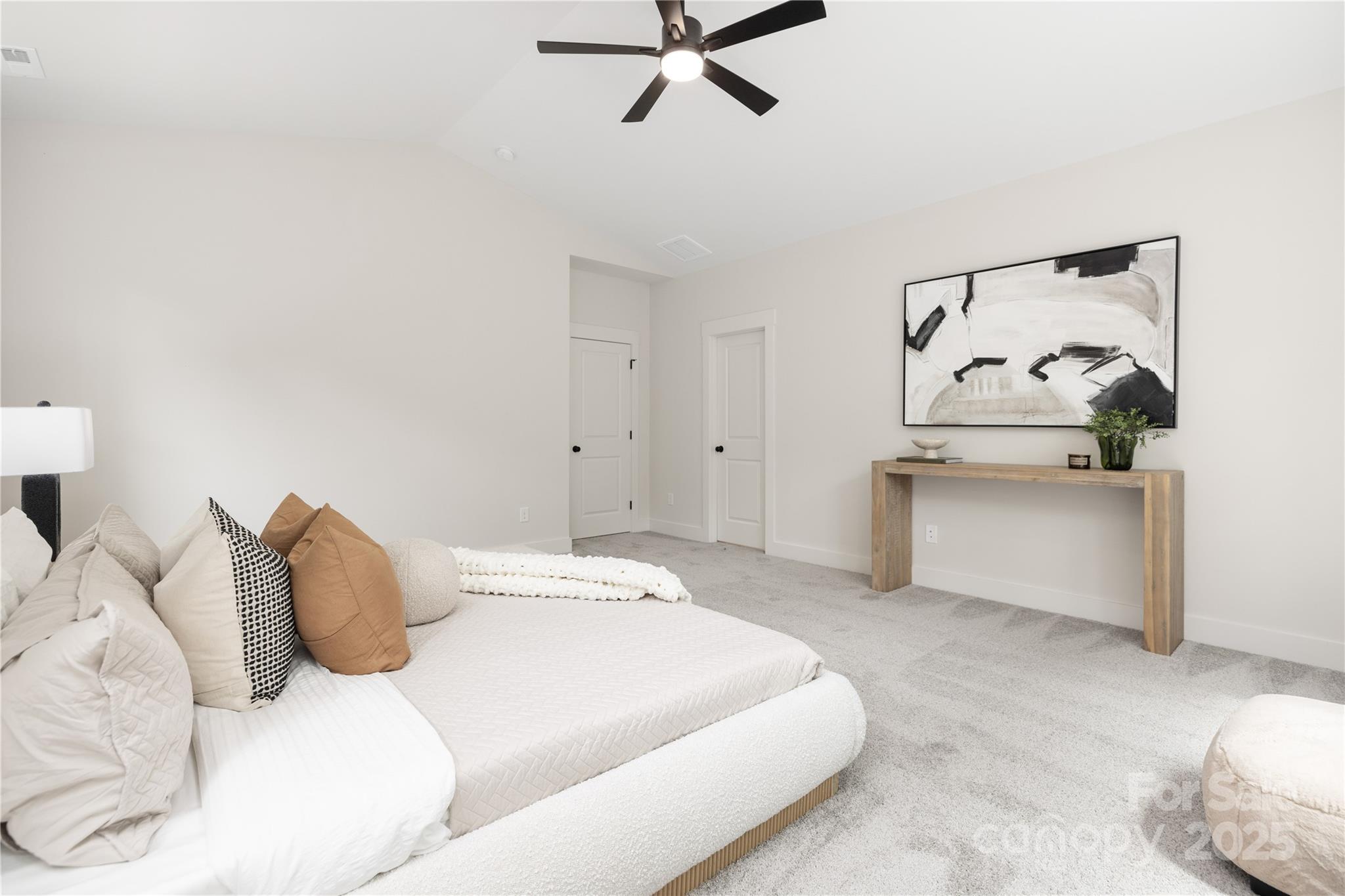 8937 Penstemons Drive Charlotte, NC 28215 - Photo 16 of 31 a bedroom with a bed and ceiling fan