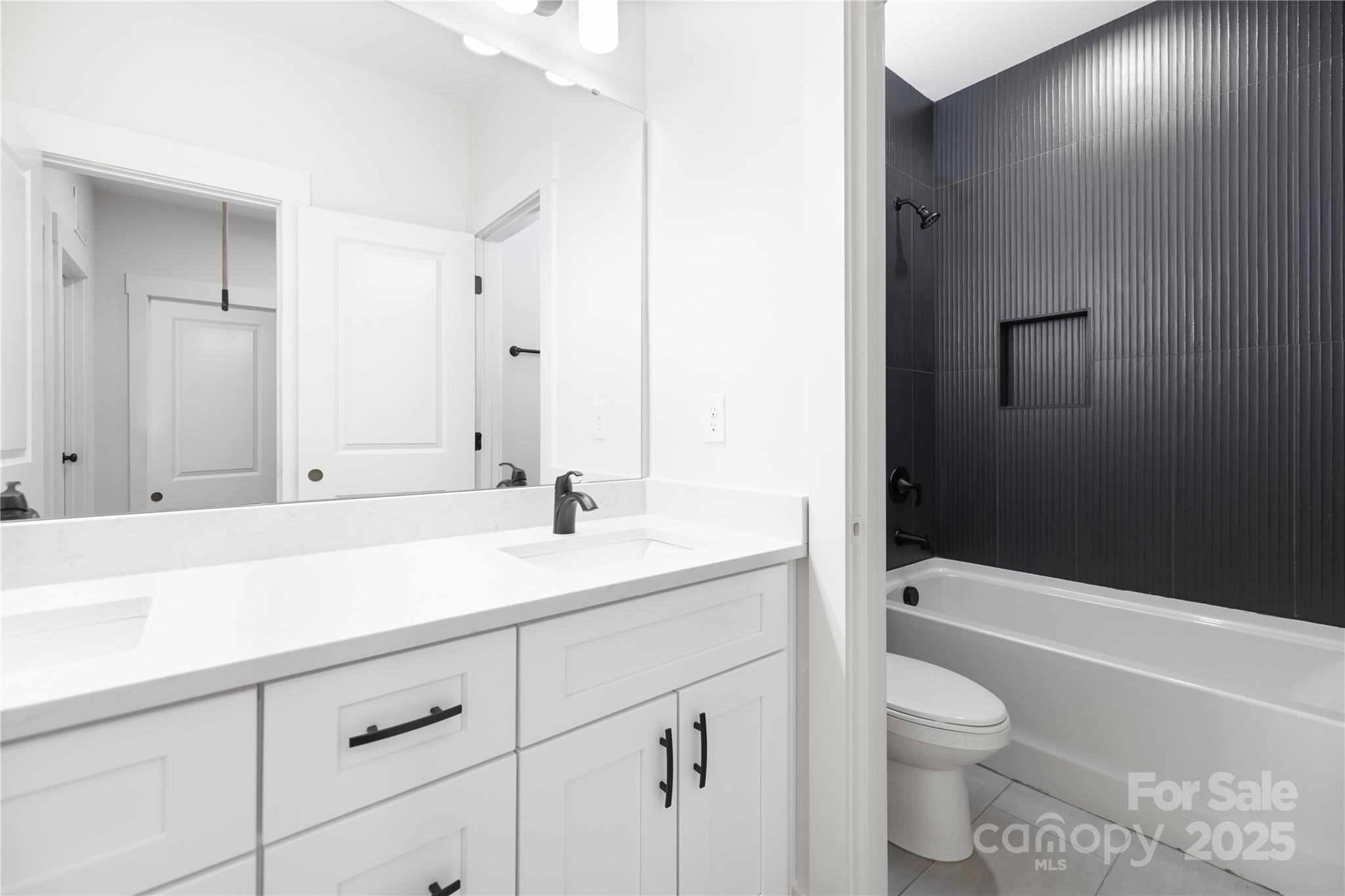 8937 Penstemons Drive Charlotte, NC 28215 - Photo 26 of 31 a bathroom with a sink a toilet and bathtub