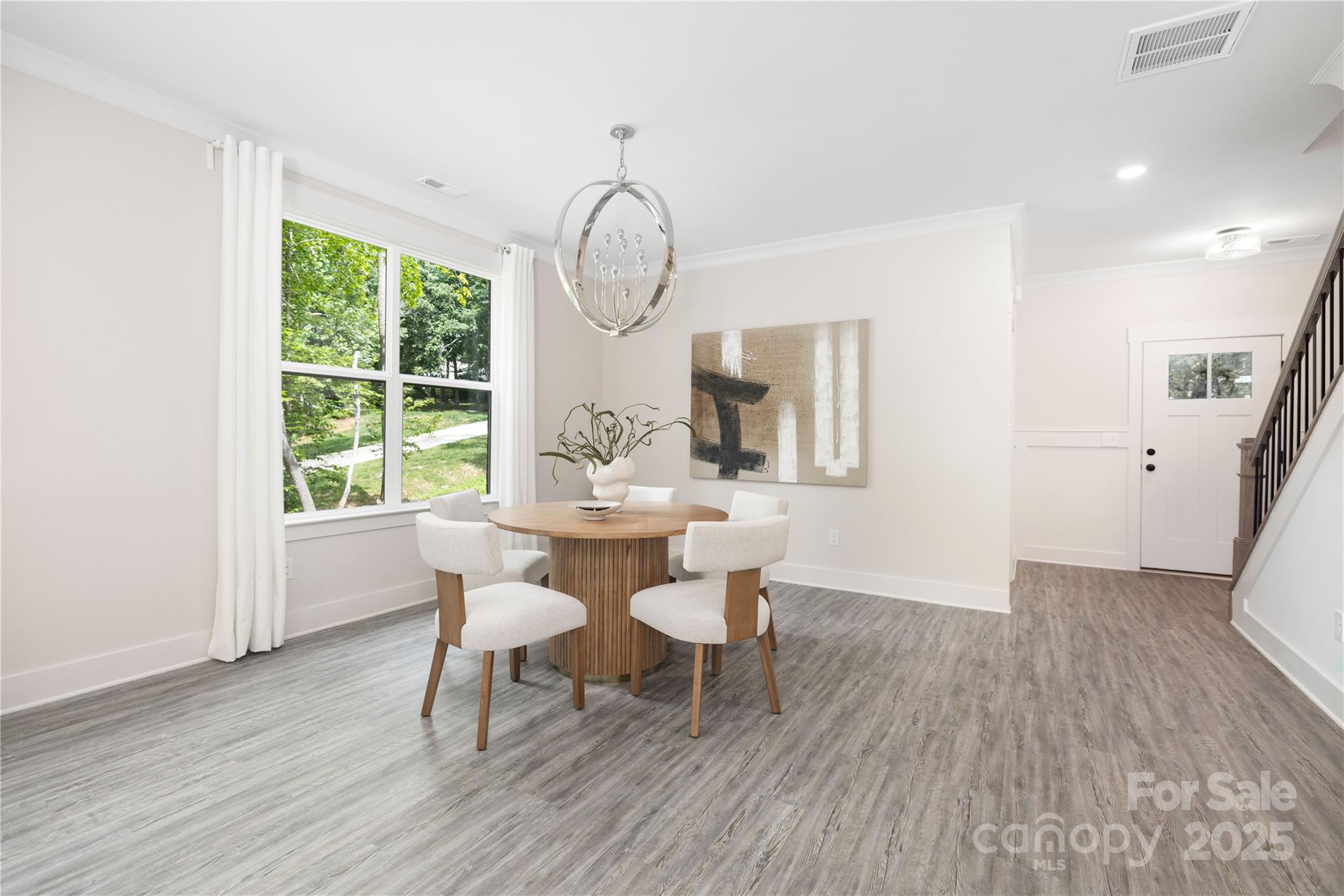 8937 Penstemons Drive Charlotte, NC 28215 - Photo 7 of 31 a dining room with wooden floor a glass table and chairs