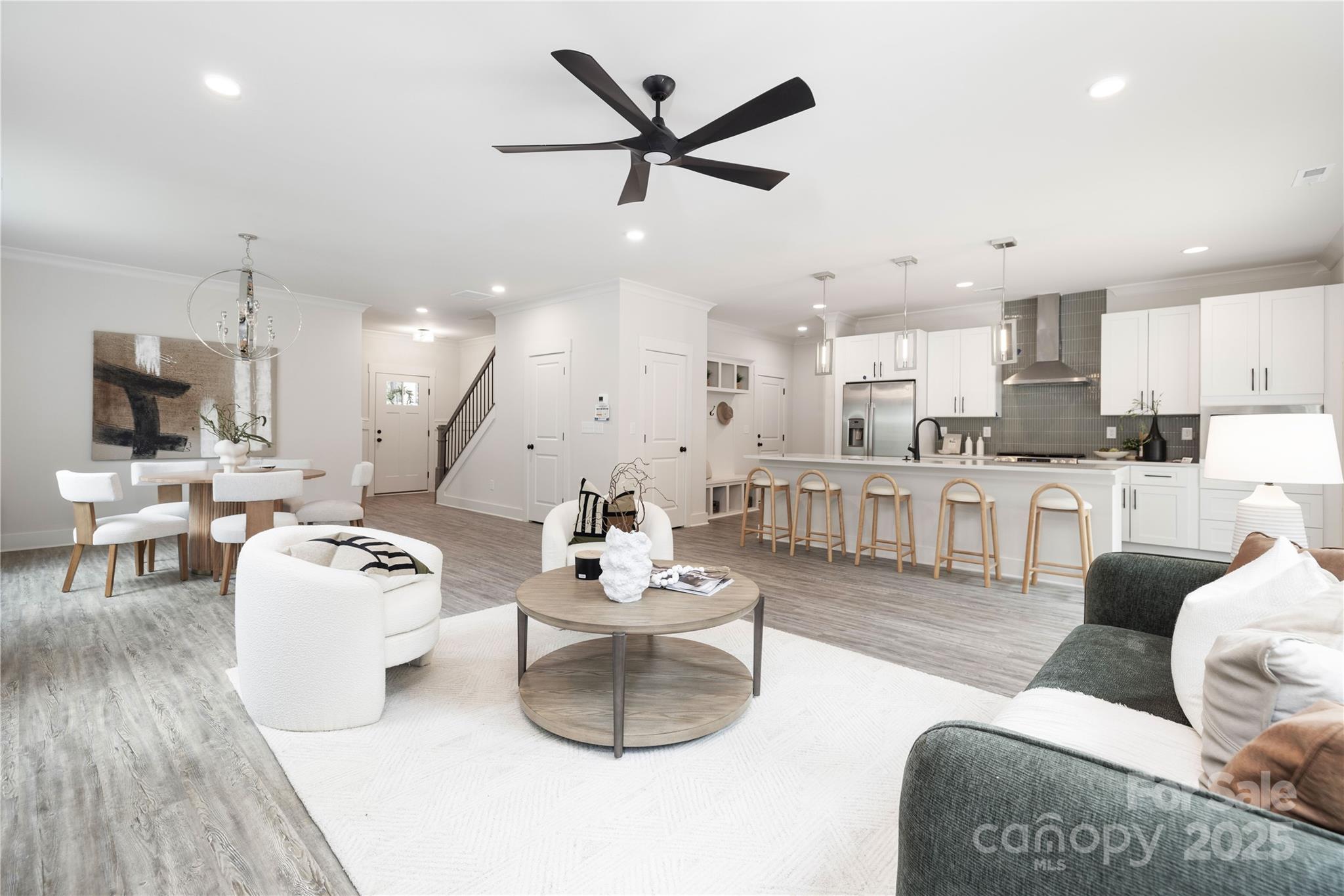 8937 Penstemons Drive Charlotte, NC 28215 - Photo 9 of 31 a living room with furniture kitchen and a chandelier