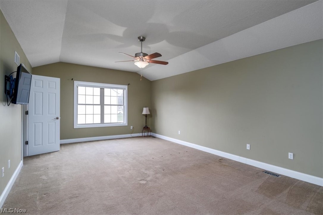 514 Silver Ridge Drive Akron, OH 44321 - Photo 21 of 47 The primary suite has vaulted ceiling with a ceiling fan and access to a private bathroom.