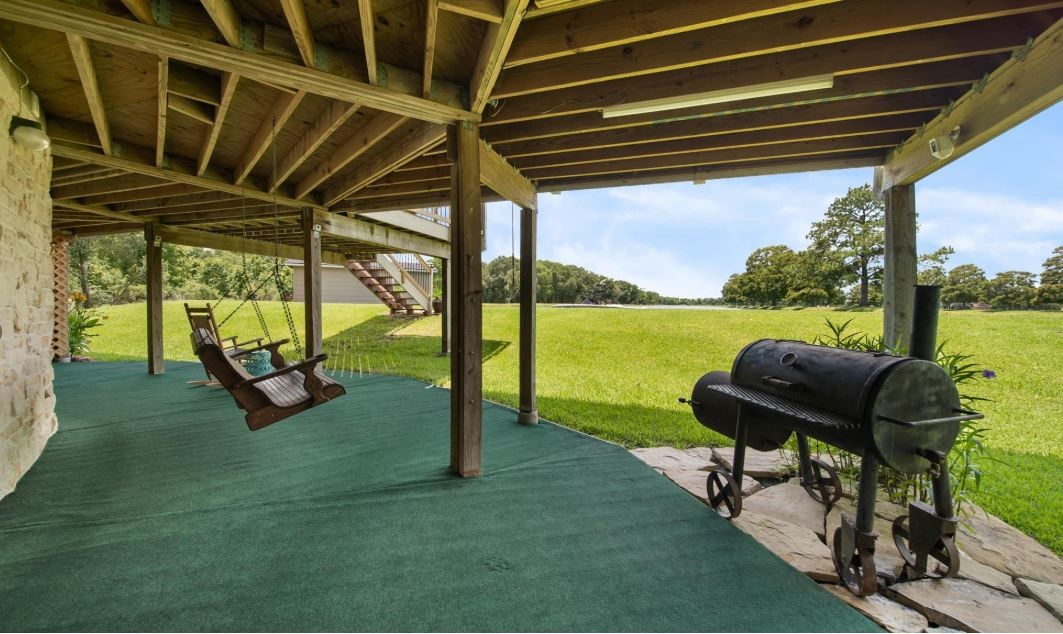 6714 Spray Lane, Unit C699A Rosharon, TX 77583 - Photo 45 of 48 Sit A While - This 1st Floor Covered Patio is Perfect for Rainy Days & Shaded Outdoor Entertaining. Notice your Private Boat House in the Center Background.