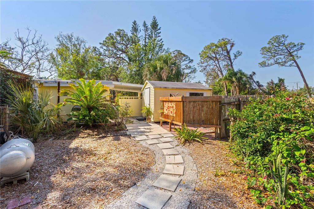 109 Burney Road Osprey, FL 34229 - Photo 45 of 56 Walkway from back yard towards the outdoor shower
