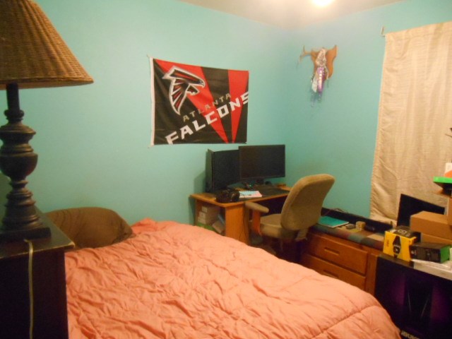 1207 Loving Street Mason, TX 76856 - Photo 6 of 10 a bedroom with a bed and a lamp on dresser