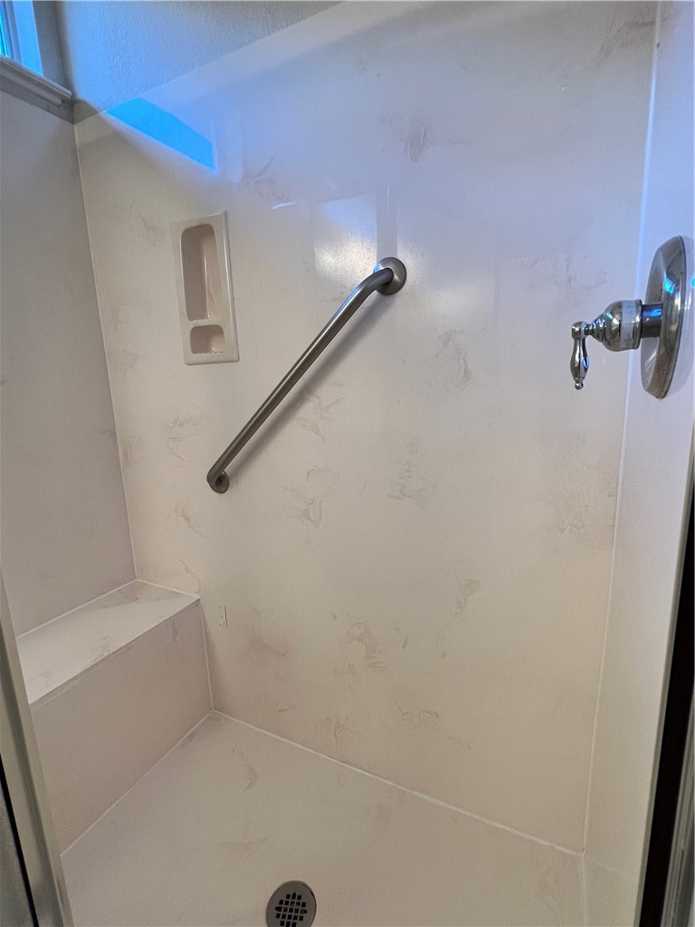 167 Whispering Wind Drive Georgetown, TX 78633 - Photo 10 of 29 Master shower with easy clean acrylic surround, grab bar and bench seat.