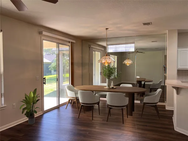 a view of a dining room with furniture window and wooden floor
