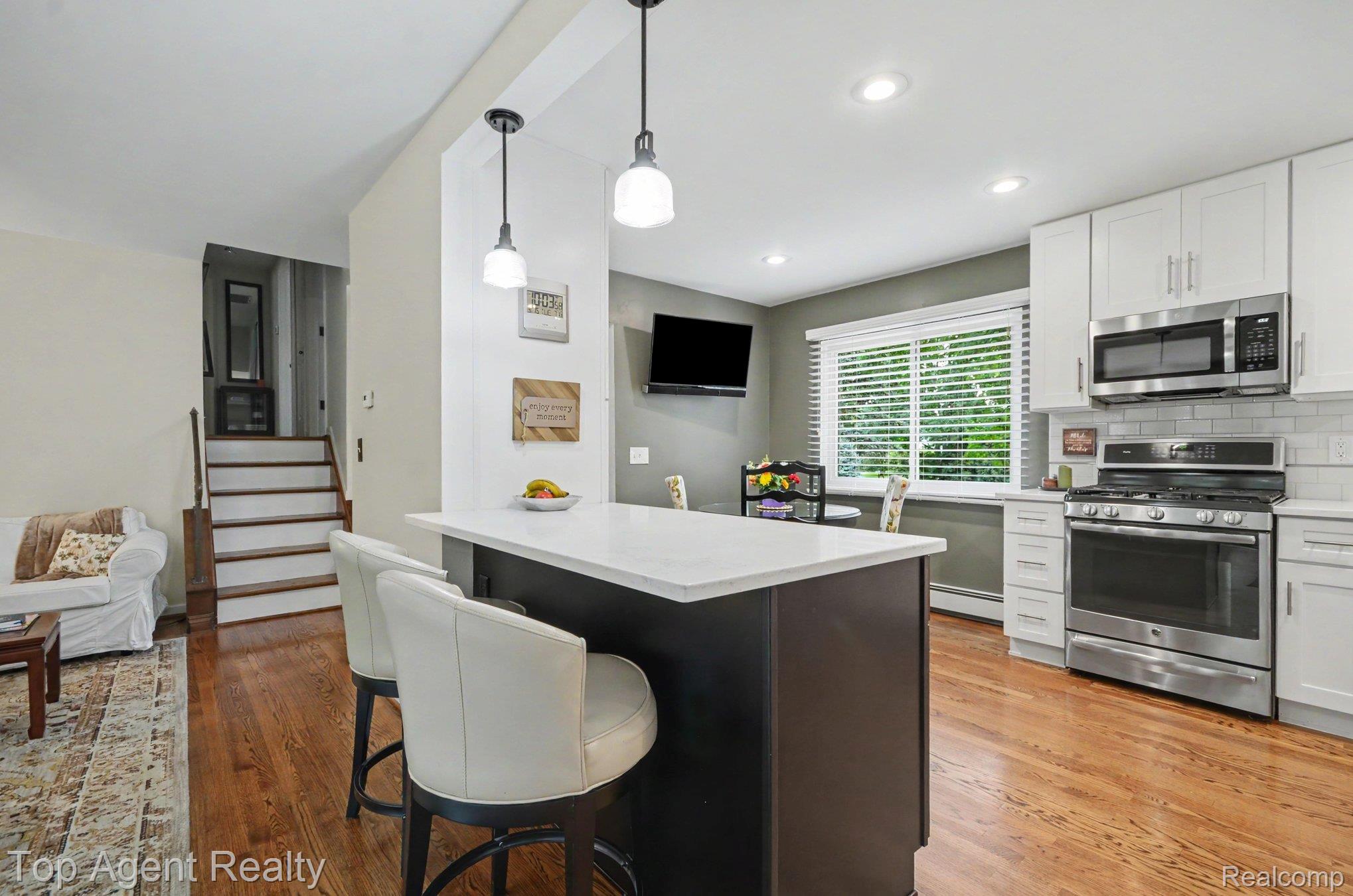 1372 New Life Lane Rochester, MI 48309 - Photo 6 of 30 Kitchen featuring white cabinetry, stainless steel appliances, a white subway tile backsplash, and a central island with pendant lighting