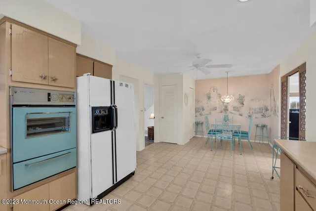 a kitchen with stainless steel appliances a refrigerator and a stove top oven