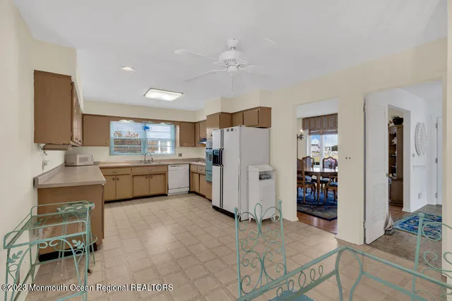 a kitchen with a refrigerator and a sink