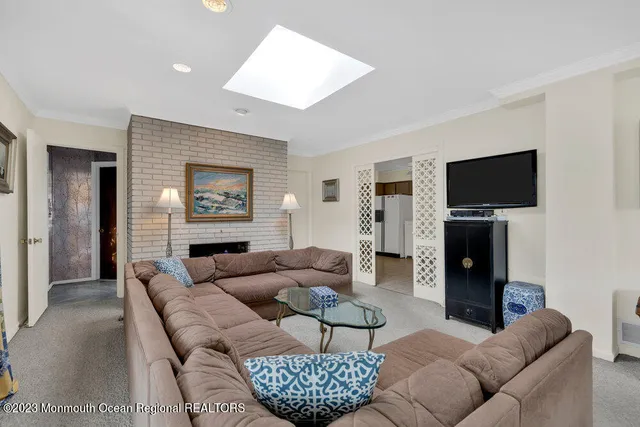 a living room with furniture a fireplace and a flat screen tv