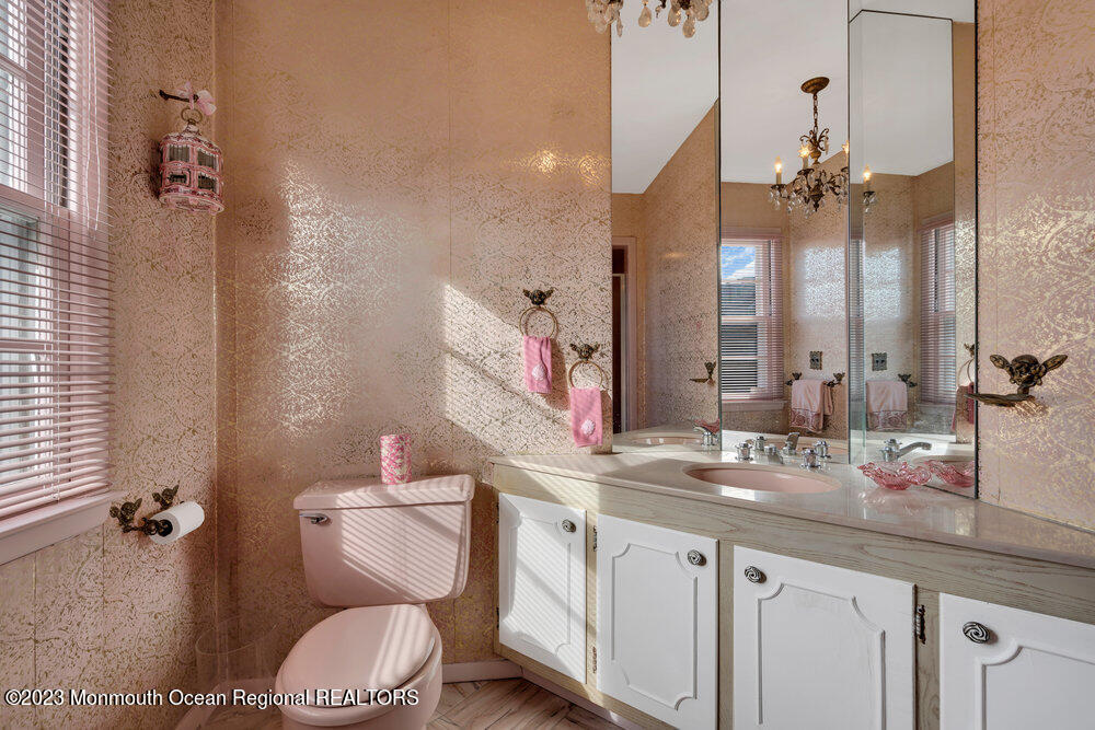 7 Howell Avenue Spring Lake, NJ 07762 - Photo 19 of 52 a bathroom with a granite countertop sink a toilet and a mirror