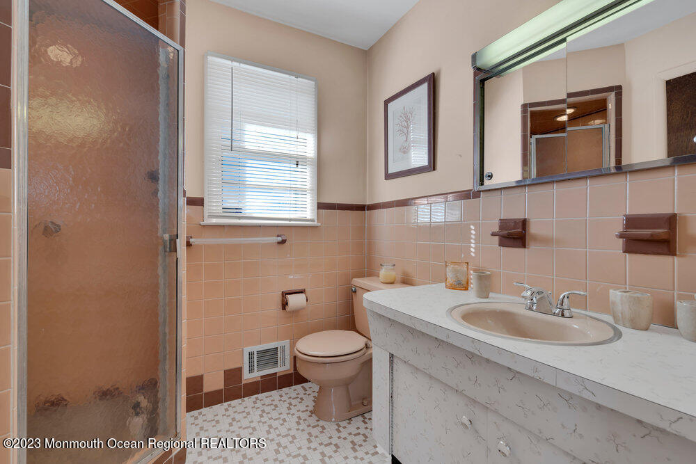 7 Howell Avenue Spring Lake, NJ 07762 - Photo 28 of 52 a bathroom with a sink a toilet and a mirror