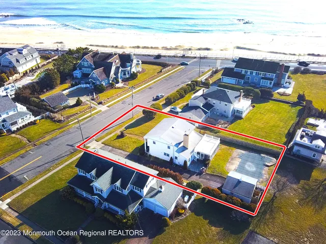 a view of a swimming pool with an outdoor seating and a yard
