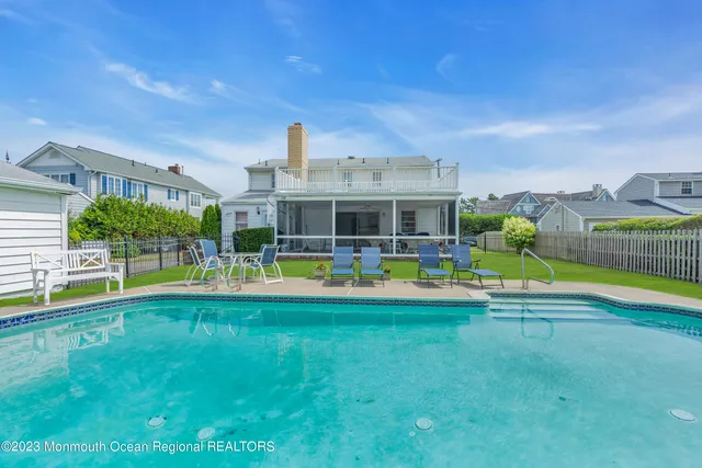 a view of swimming pool with outdoor seating and plants