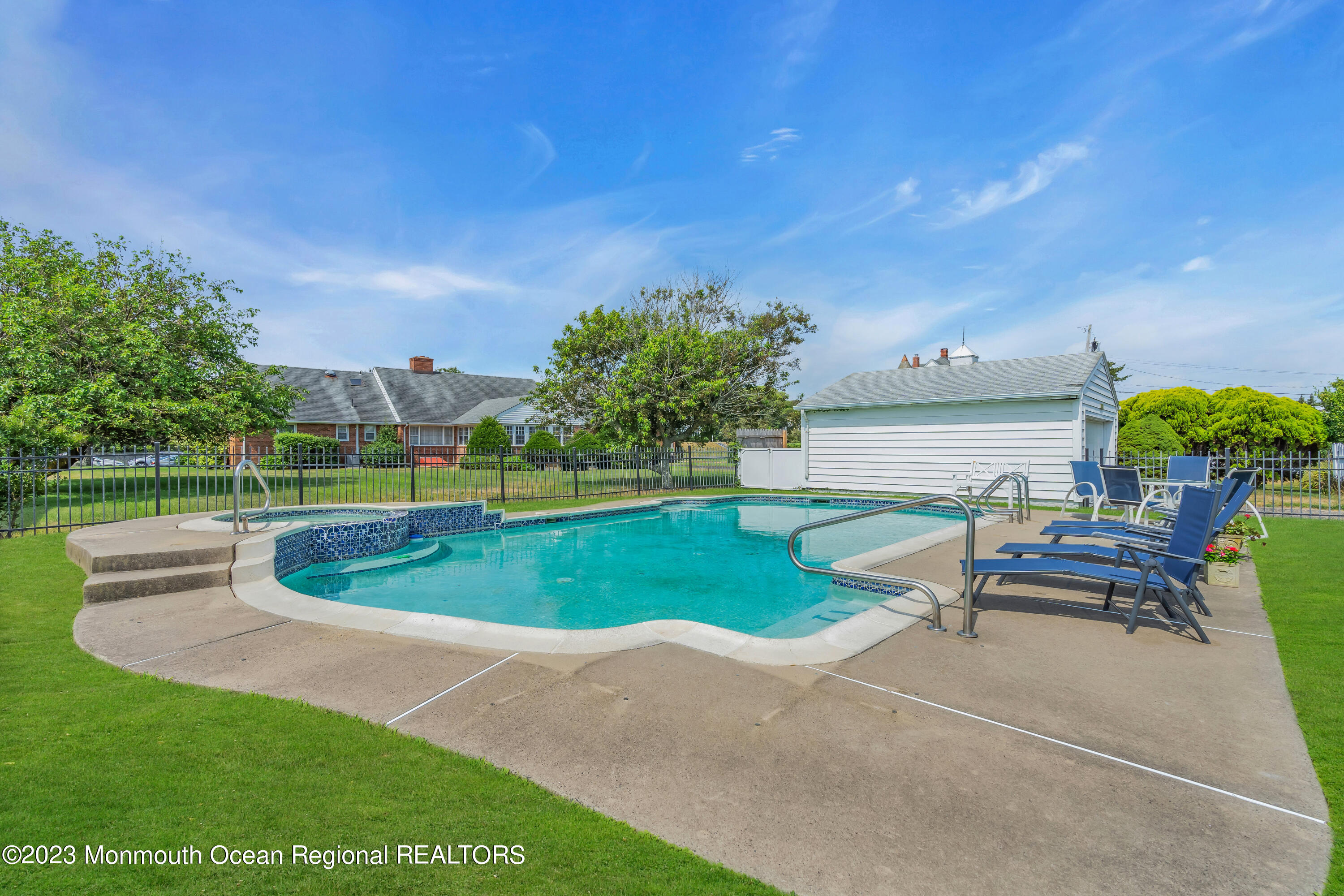 7 Howell Avenue Spring Lake, NJ 07762 - Photo 50 of 52 a view of a swimming pool and lounge chairs in back yard of the house