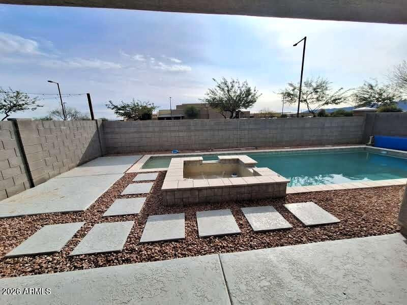 18541 West Mescal Street Surprise, AZ 85388 - Photo 6 of 31 a small pool is sitting in the middle of a yard