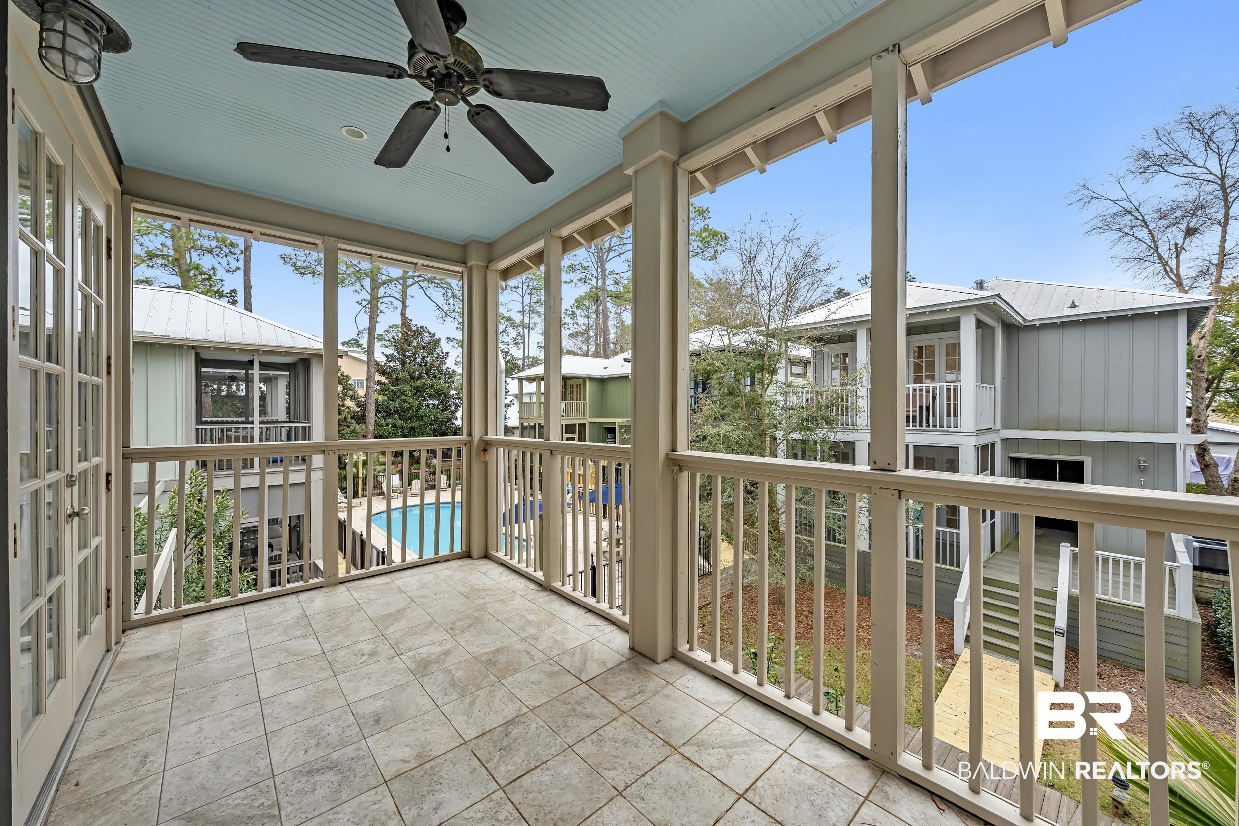 25773 Canal Road, Unit 32 Orange Beach, AL 36561 - Photo 21 of 35 Unfurnished sunroom featuring a ceiling fan and a balcony