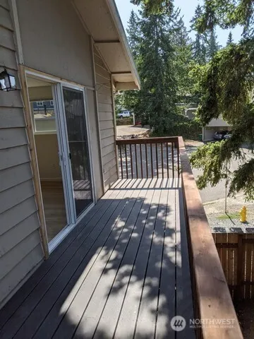 a view of walk in closet with wooden floor