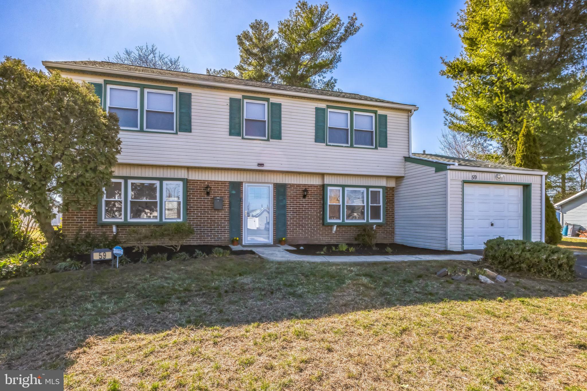 59 Manor Lane Willingboro, NJ 08046 - Photo 1 of 28 a front view of a house with a yard and garage