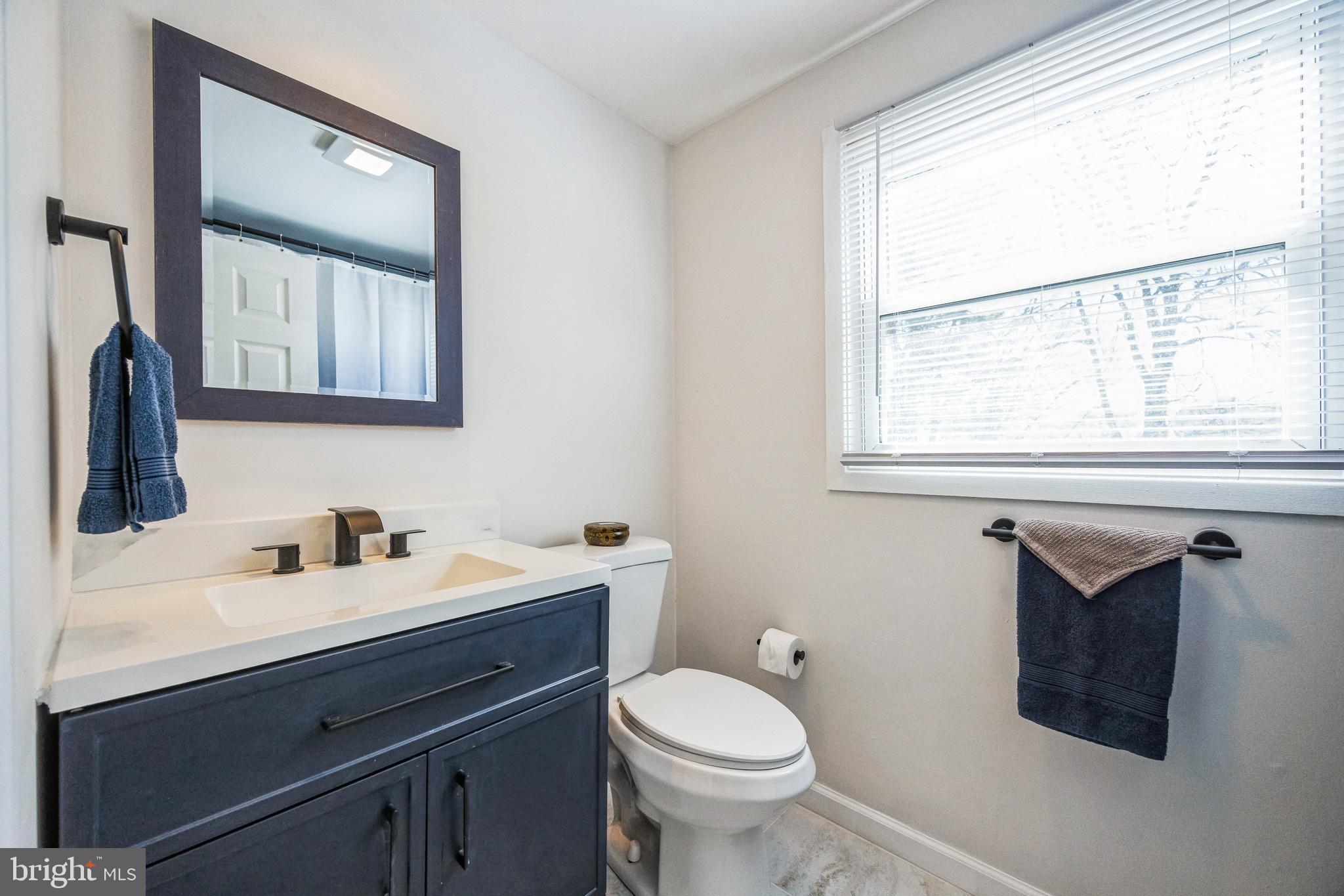 59 Manor Lane Willingboro, NJ 08046 - Photo 26 of 28 a bathroom with a toilet sink and mirror